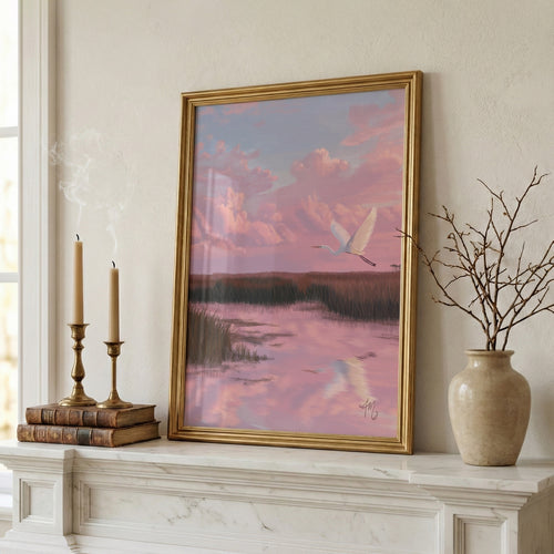A Wider Sky coastal marsh art styled in a gold frame on a mantel